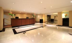 a lobby of a hotel with a reception desk at Hotel Windsor House Inn By GEH Suites in Bogotá