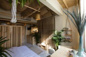 a room with a bed and plants in it at Biophilia Luxury Lofts in Beirut