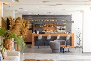 a bar in a restaurant with chairs and a counter at Luxotel Cannes in Cannes