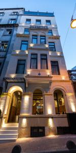 a tall white building with lights on it at Hotel Balo in Istanbul