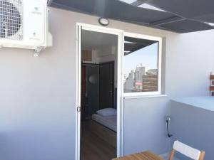 a room with a sliding glass door with a window at Athens downtown rooftop loft #1 in Athens