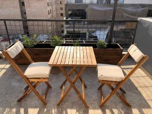 a wooden table and two chairs next to a table at Athens downtown rooftop loft #1 in Athens