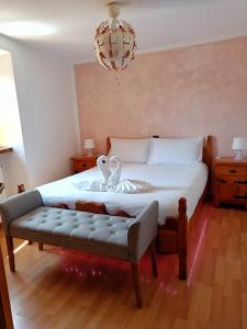 a bedroom with a bed with two swans on it at Ca' di Aroha in Musignano