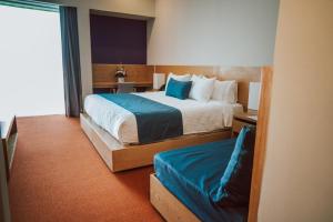 Łóżko lub łóżka w pokoju w obiekcie Gran Hotel Concordia