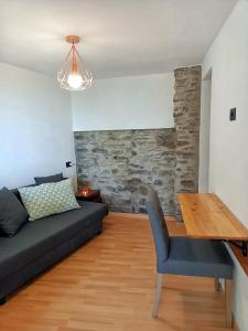 a living room with a couch and a wooden table at Ca' di Aroha in Musignano