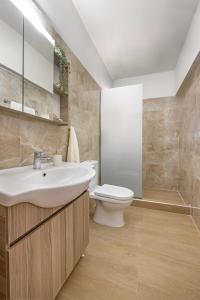 a bathroom with a sink and a toilet at Panormos Luxury House in Rhodes Town