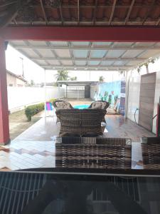 a patio with two couches and a swimming pool at Casa temporada Lucena in Lucena