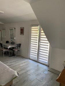a room with a staircase with a door and a table at Iskra DDUR in Gornji Milanovac