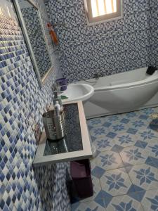 a bathroom with a sink and a toilet and a tub at Chambre privée meublée climatisée in Ziguinchor +32 photos