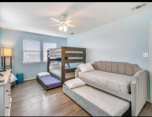 a living room with a couch and a bunk bed at Beachfront Envy in Galveston