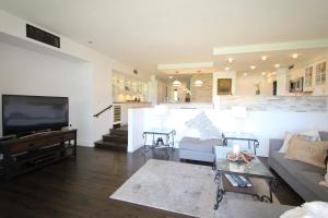 a living room with a couch and a tv at Kaanapali Royal Golf Retreat in Lahaina