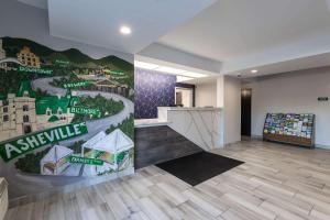 an empty lobby with a mural of a village at Rodeway Inn & Suites near Outlet Mall - Asheville in Asheville