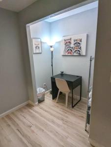 a room with a desk and a table and a lamp at 2 bedroom* Minutes from downtown *Firepit in Colorado Springs