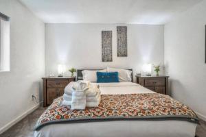 a bedroom with a large bed with blue pillows at 2 bedroom* Minutes from downtown *Firepit in Colorado Springs