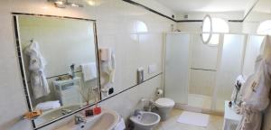 a bathroom with a sink and a toilet and a shower at Hotel La Pigna in Marina di Pietrasanta