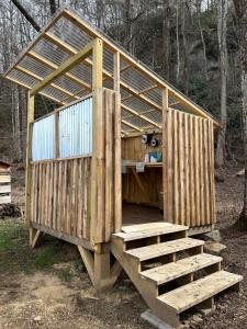 a wooden structure in the middle of a forest at Growing Faith Farms in Moravian Falls