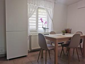 a kitchen with a table and chairs and a window at Lovely Apartment With Courtyard in Mangalia +7 photos