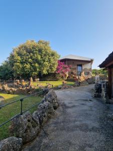 un chemin devant une maison avec des rochers dans l'établissement Tenute Delogu Wine Resort, à Santa Maria la Palma