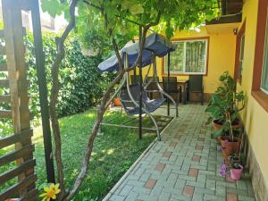 a gazebo in the backyard of a house at Lovely Apartment With Courtyard in Mangalia