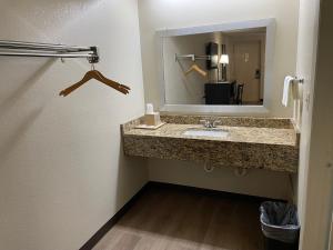 a bathroom with a sink and a mirror at Royal Inn Motel in Fredericksburg