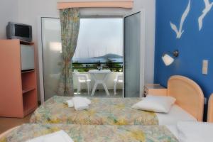 Postel nebo postele na pokoji v ubytování Ifigenia Hotel