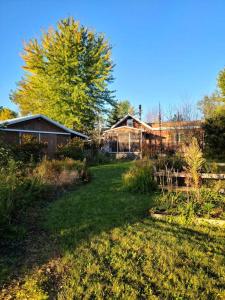 a yard with a house and trees and a house at Country Cottage in Penn Yan +17 photos