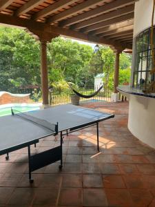 a ping pong table sitting on a patio at Casa vacacional en escuintla in Guatemala