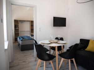 a living room with a table and chairs and a couch at Apartamenty MARINA Puck in Puck