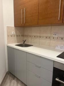 a kitchen with white cabinets and a sink at Perfect Studio Rossio in Lisbon