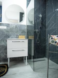 a bathroom with a white sink and a shower at Apartamenty MARINA Puck in Puck +55 photos