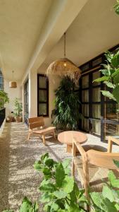 a patio with benches and a table and some plants at Biophilia Luxury Lofts in Beirut