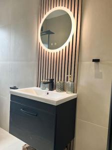 a bathroom with a sink and a mirror at Farsley Cottage in Farsley +22 photos