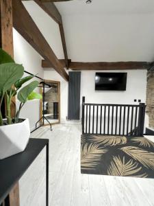 a living room with a bench and a potted plant at Farsley Cottage in Farsley