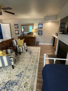 a living room with a couch and a fireplace at River House Inn in Snow Hill