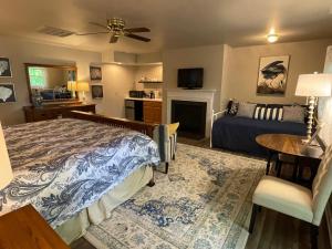 a bedroom with a bed and a living room at River House Inn in Snow Hill
