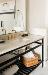 a bathroom with a sink and a mirror at Emeline in Charleston