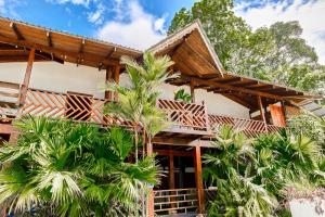 a house with palm trees in front of it at Elena Brown in Puerto Viejo +43 photos