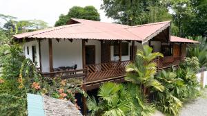 a small house with a red roof at Elena Brown in Puerto Viejo