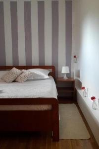 a bedroom with a bed and a striped wall at Apartments with parking space Zaboric, Sibenik - 21367 in Zaboric