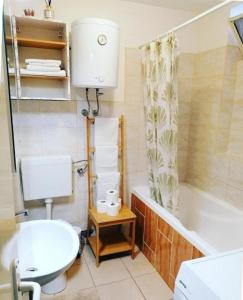 a bathroom with a toilet and a tub and a sink at Apartments with parking space Zaboric, Sibenik - 21367 in Zaboric