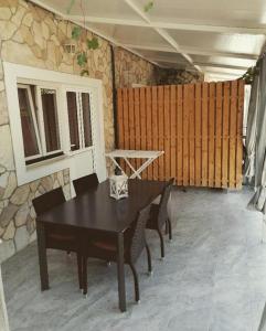 a dining room with a table and a stone wall at Apartments with parking space Zaboric, Sibenik - 21367 in Zaboric +7 photos