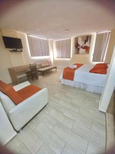 a hotel room with two beds and a television at Terraza Dreams in Quito