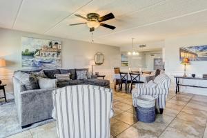 a living room with a couch and a ceiling fan at Steps to Oceanside Condo in Amelia Island
