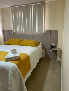 a bedroom with two beds with yellow sheets and a window at Terraza Dreams in Quito
