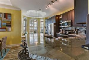 a large kitchen with a glass counter in it at Ocean Place Beach Condo in Fernandina Beach