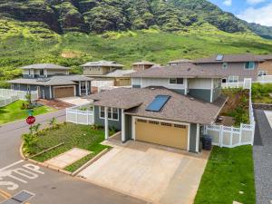 an aerial view of a house with a mountain in the background at Studio Nene - Mountains, Beaches, King Bed, Pool & Gym in Waianae