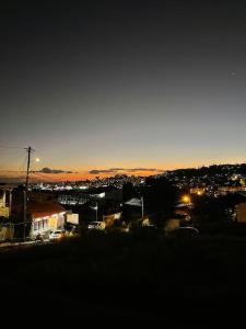 a view of a city at night with the sun setting at KayChouchou- Appart cosy au cœur de Fort-de-France in Fort-de-France