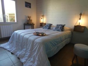 a bedroom with a bed with a tray on it at Maison rénovée, 8 pers, animaux admis, jardin - FR-1-540-188 in Notre-Dame-de-Monts