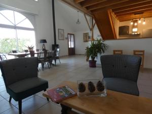 a living room with a table and chairs at Maison rénovée, 8 pers, animaux admis, jardin - FR-1-540-188 in Notre-Dame-de-Monts +16 photos