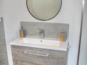 a bathroom with a sink and a mirror at Gîte Confortable avec Jardin Privatif à Proximité des Châteaux de la Loire et Zoo de Beauval - FR-1-381-512 in Chenonceaux +14 photos